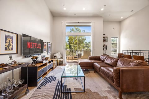 The main living area on the top floor, connecting directly to the outdoor balcony.