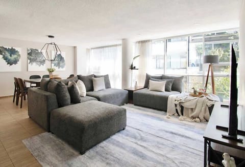 A bright perspective of the living room and dining area with beautiful natural light