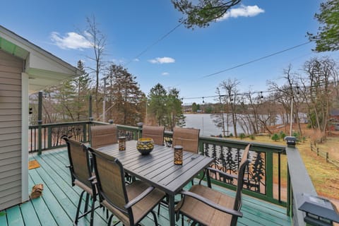 Lake-view deck with dining for six and string lights—perfect sunset meals.