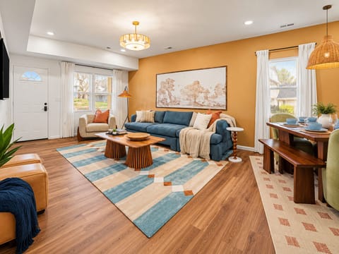 Bright living room with colorful décor and comfortable seating.