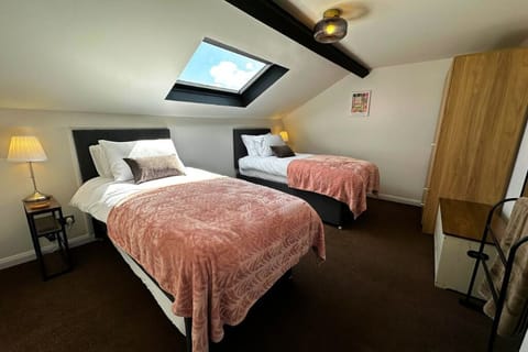 A simple, peaceful twin room with soft tones and a relaxed feel — designed to help you rest and recharge.