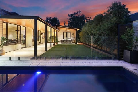 Spacious private outdoor area with pool, lawn and all‑weather alfresco