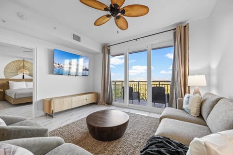Relax in the modern living room with balcony access and natural light.