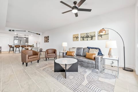 Modern living room with leather chairs and aviation-themed artwork for a stylish stay.