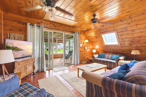 Living space extends to a screened porch overlooking resort grounds.