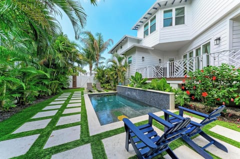 Stunning tropical oasis with private pool surrounded by lush palms and colorful blooms—your perfect paradise escape.