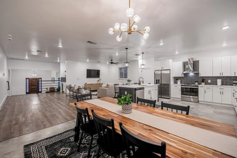 The large dining table is large enough plus additional seats at the bar. 