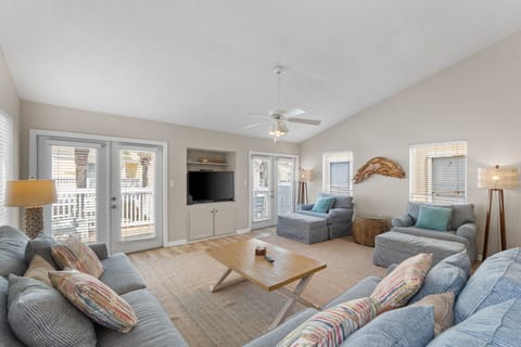 Sink into plush sofas after a day of adventure. This airy living room offers peaceful beach vibes with coastal accents, comfy seating for the whole group, and your personal deck just steps away.