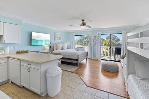 Relax in your bright coastal suite with king bed, bunk beds, kitchenette, and balcony access—perfect for families seeking comfort and convenience.