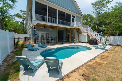 Private fenced pool oasis with screened porch and shaded patio seating