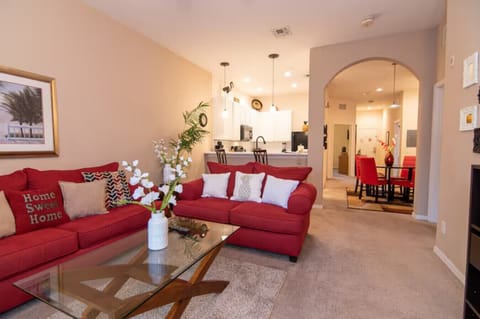 Bright and inviting living room with comfortable seating and an open layout to the kitchen and dining area.