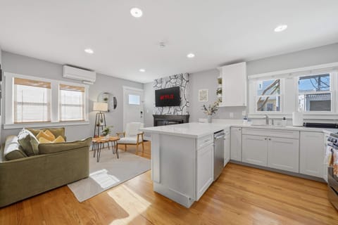 Spacious kitchen with island seating and stainless steel appliances.