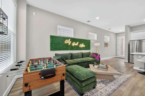 Living Room: Enjoy vibrant fun with foosball and natural light in this stylish space!