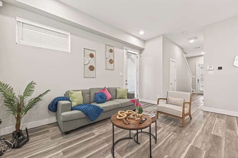 Bright, modern living room with cozy seating, stylish décor, and open layout—perfect for relaxing, streaming, and unwinding during your Airbnb stay.