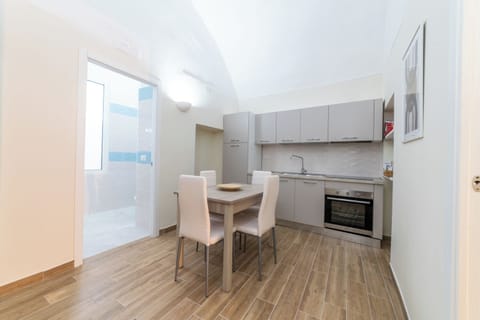 Apartment (1 Bedroom) | Private kitchen | Stovetop, cookware/dishes/utensils, dining table