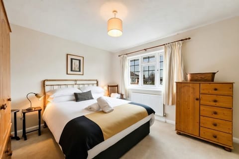 Bedroom Retreat: Chic decor, comfortable textiles, and inviting natural light await your relaxation!