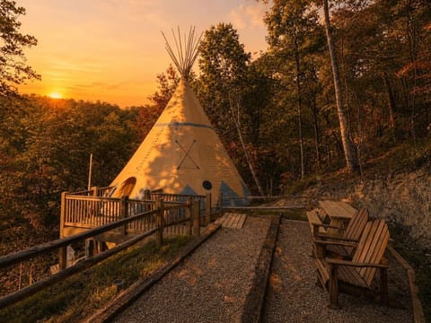 Stunning sunset view of the luxury teepee exterior and private wooden deck.