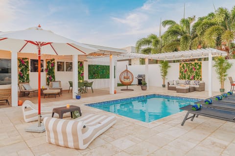 Open backyard layout with pool, lounge, and dining spaces