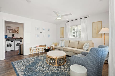 Sink into plush seating while the ceiling fan keeps you comfortable in your bright, coastal-inspired living space.