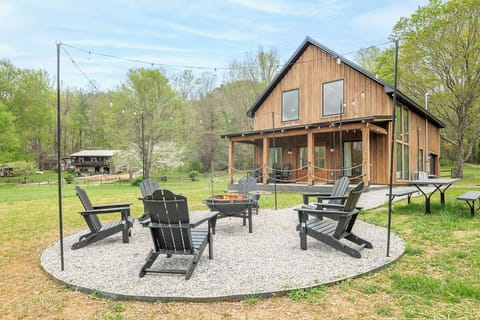 Gather around the crackling fire pit where marshmallows toast and stories flow beneath twinkling string lights on this peaceful gravel patio.