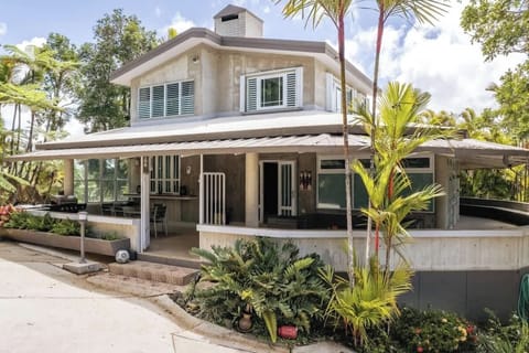 Heliconia House (in the field) on two levels.