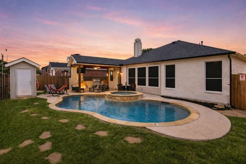 Backyard oasis in Texas—sparkling pool, spa, and sunset skies made for evening dips and laid-back lounging.
