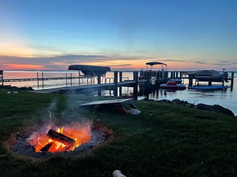 Golden hour, crackling fire, and calm waters.