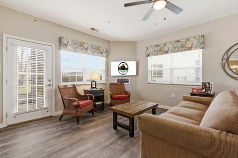 The living area is spacious and includes cable TV, a sleeper sofa, and patio access