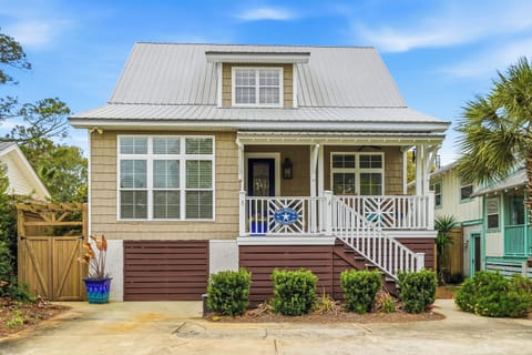 1129 Peachtree Street — St. Simons Island vacation home, 4-minut - Two-story home on one of the island's best streets — metal roof, covered porch, palm trees, and Myrtle Street beach access four minutes on foot.