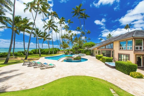 Welcome to your private oceanfront retreat with pools, palms, and sweeping coastal views.