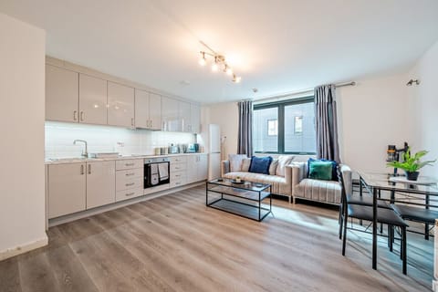 An easy space to prepare meals and unwind, with the kitchen along one wall and seating by the window.