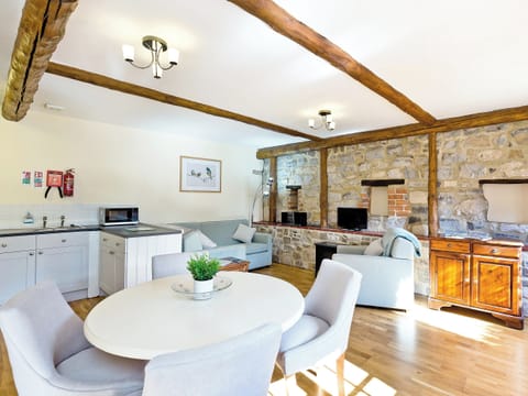 Exposed feature wall and wooden beams in living area | Wisels Cottage - Knockerdown Cottages, Carsington, near Ashbourne