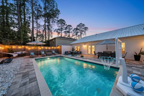 Welcome to your private heated pool oasis at Beachside Dream, perfect for unwinding after a day at the beach. Enjoy spacious outdoor living with mood lighting, comfortable seating, and a fun basketball hoop!