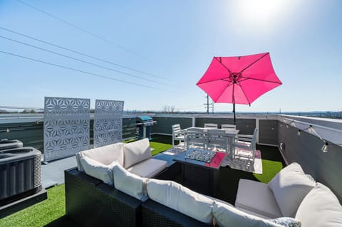 Cozy outdoor dining space under a bold umbrella, ideal for shared meals 