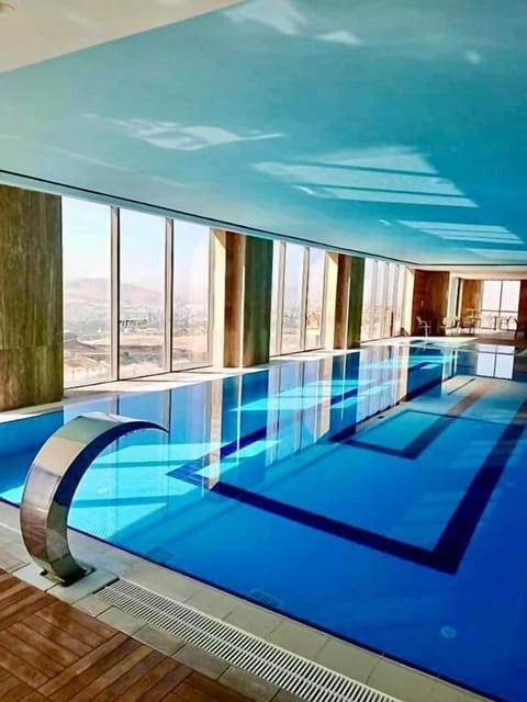 Indoor pool, pool umbrellas, sun loungers