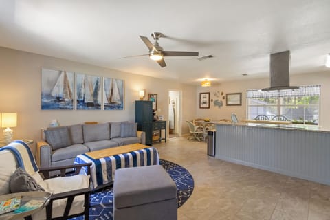 Enjoy the perfect flow of this open-concept home, where the comfortable living area leads right into a charming dining nook and modern kitchen breakfast bar.