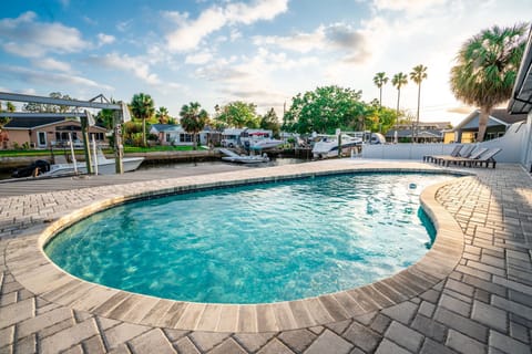 Dive into crystal-clear waters while tropical palms sway overhead, your private waterfront oasis awaits.