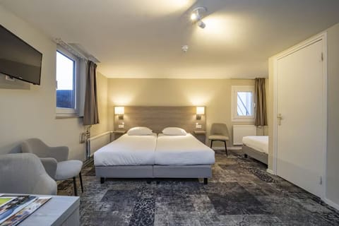 Gather and unwind in a spacious room with multiple beds.