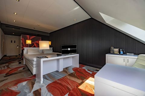 Unwind in the stylish loft room with cozy seating corner.