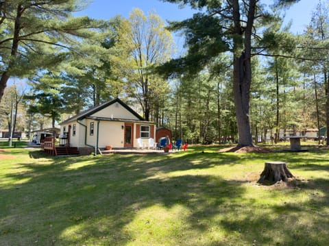 Cozy woodland cottage with a spacious yard, patio seating, and fire pit