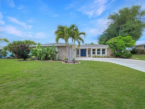 Charming home with lush landscaping and a welcoming front entrance.