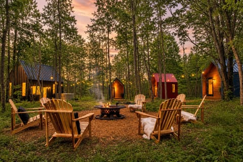 String lights and glowing cabins light up the property at dusk.