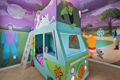A colorful, adventure-inspired bedroom with a unique van-style bed and playful murals, perfect for sparking imagination and giving kids a memorable stay.