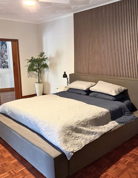 This room feels like a retreat with a large king bed, electric fire and seating.