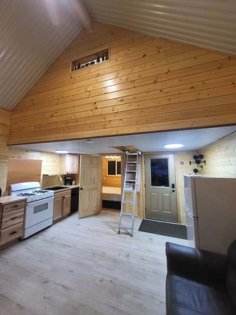 Back door you come in, Fridge, Artic Ladder to loft, Master bedroom, and Kitchen