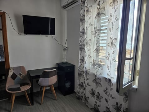 Deluxe Triple Room, Sea View | Desk, laptop workspace, bed sheets