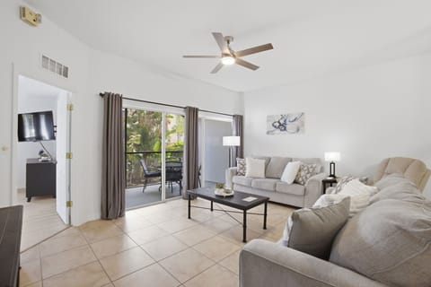 Spacious, open-concept living room with plenty of seating and direct access to your private screened-in patio.