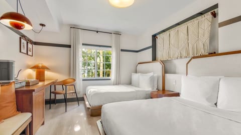 Unwind in bright, airy comfort with two crisp beds.