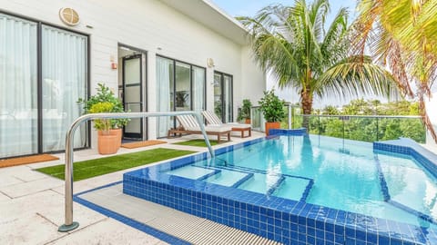 Unwind by the sparkling plunge pool with breezy tropical views.