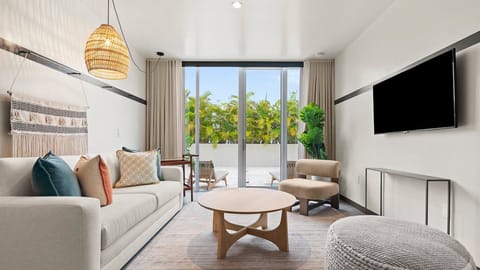 Unwind on the sofa with lush terrace views beyond.